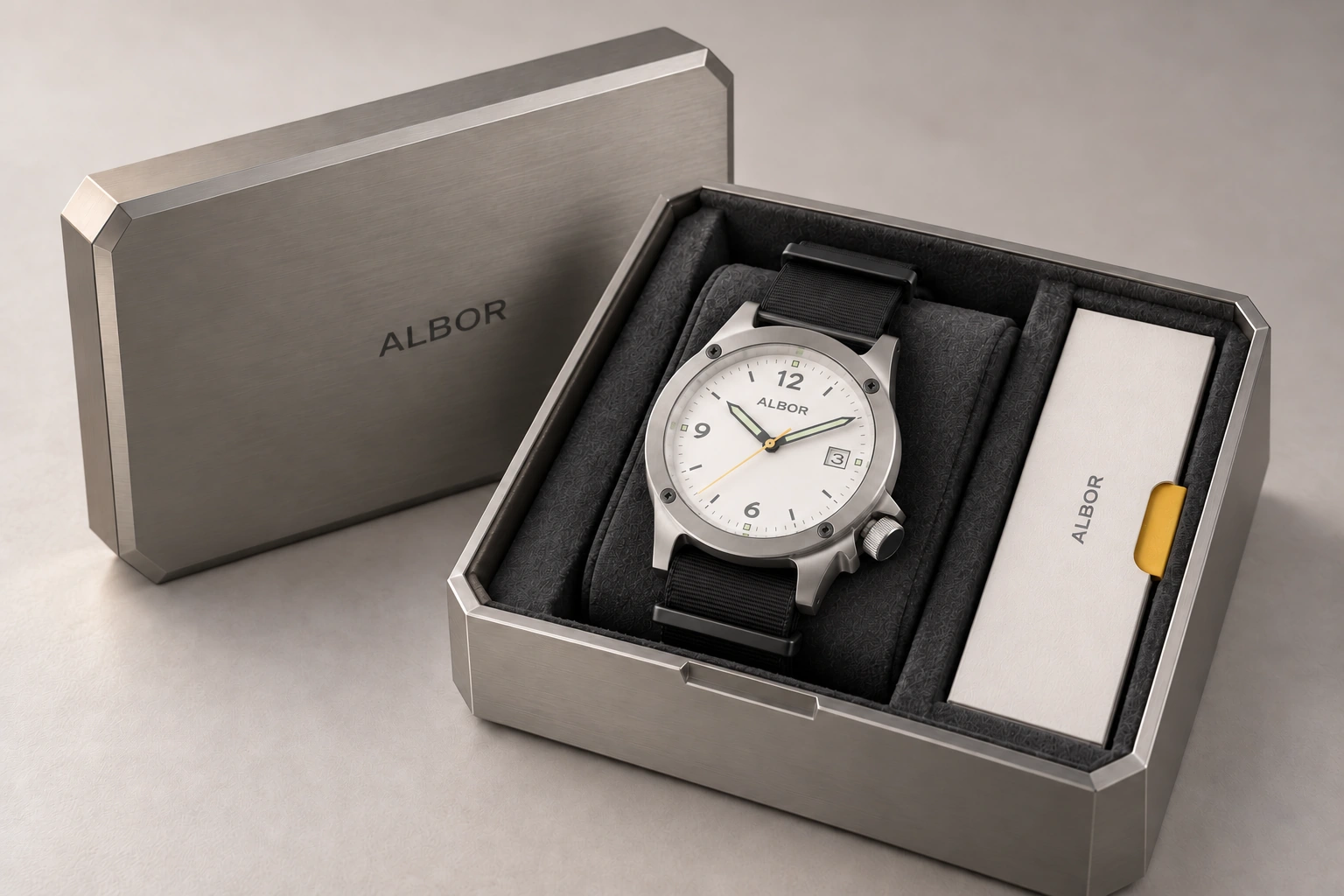 Instrument Case concept: brushed-metal chamfered container with dark fitted interior and documentation compartment with the current integrated-lug ALBOR watch