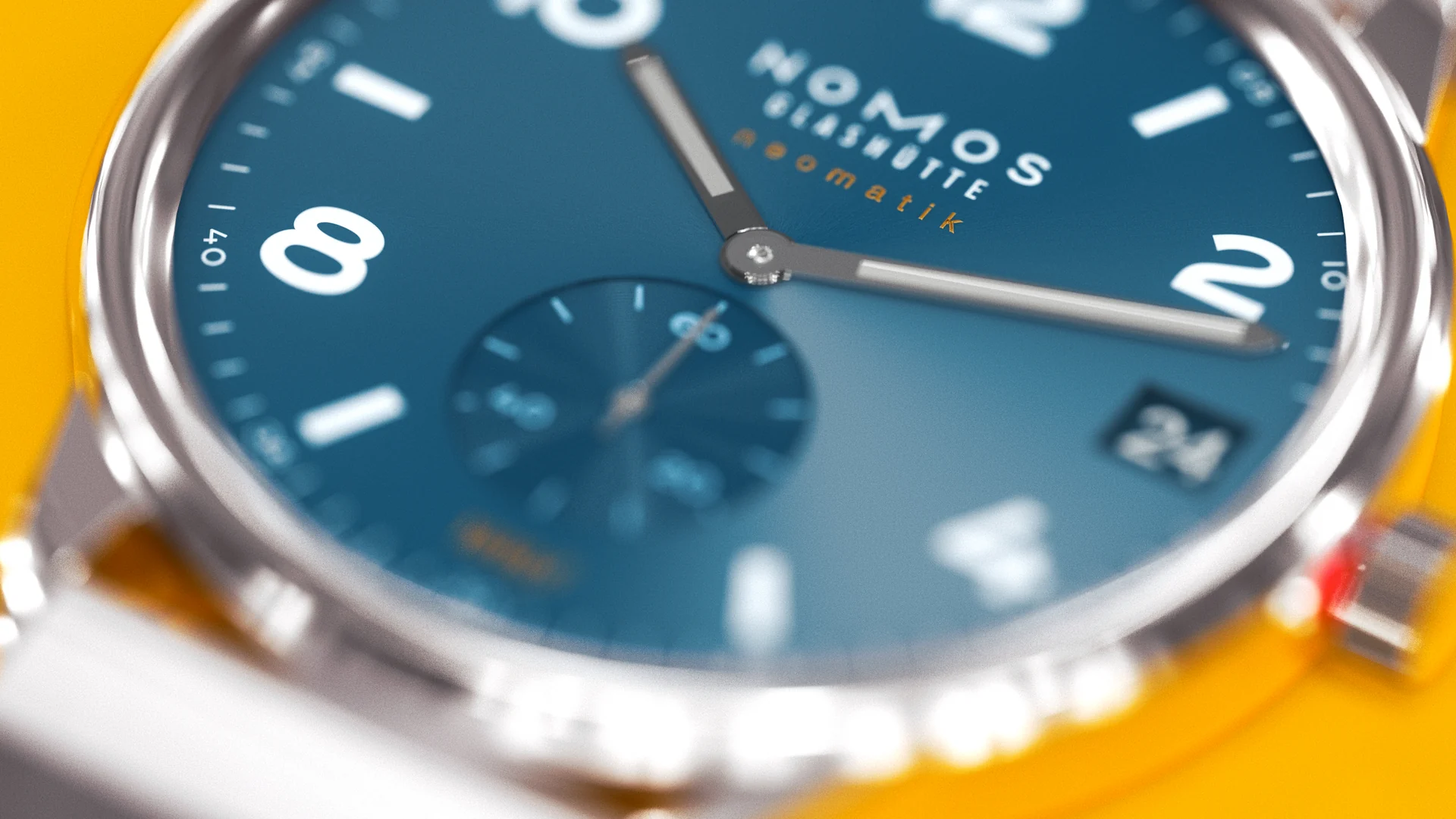 Macro view of the blue NOMOS dial over a yellow surface